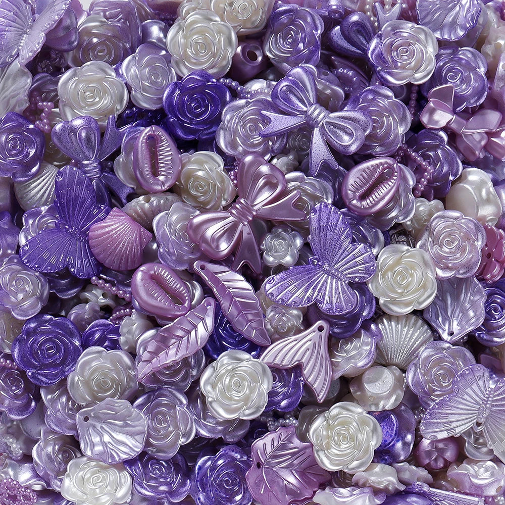 A close-up of iridescent purple and white butterfly shell acrylic beads for DIY jewelry making