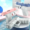 A collection of white and pink tactical water blaster pistols are displayed on a blue surface.