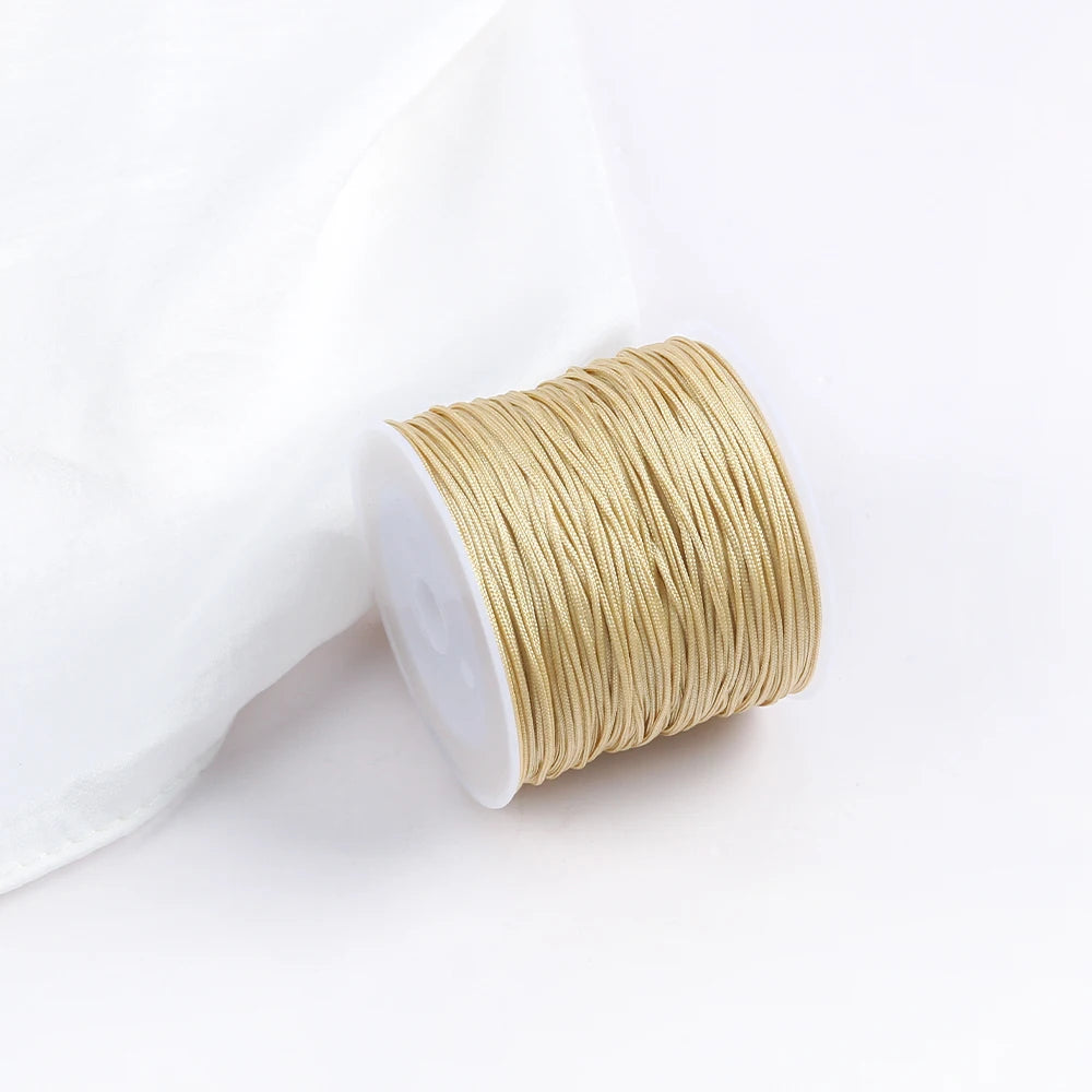 A roll of golden beige cotton nylon macrame cord for jewelry making and crafts.