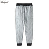 Gray waterproof winter pants for kids with a black waistband