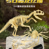A yellow dinosaur skeleton fossil is displayed on a white surface with tools, suggesting a DIY excavation kit.