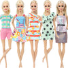 Five dolls wearing colorful casual outfits including tops, skirts, and shorts