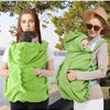 A woman is holding a green baby windproof cape blanket with a dinosaur design for a baby.