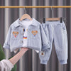 A light blue corduroy jacket and matching pants set for a child, displayed on a hanger.