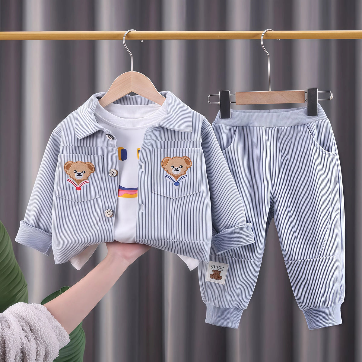 A light blue corduroy jacket and matching pants set for a child, displayed on a hanger.