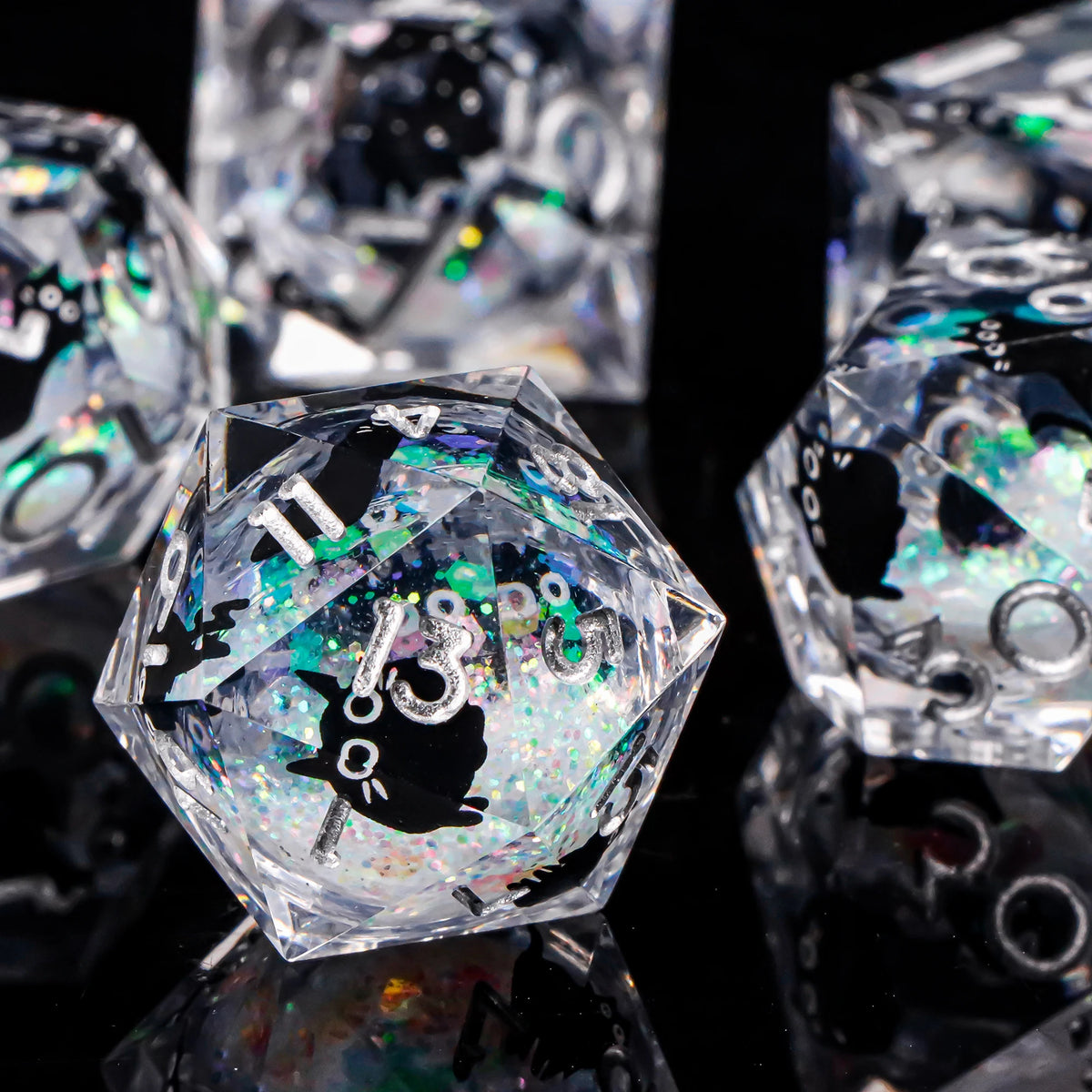 A close-up of a set of iridescent liquid core dice, including a hexagonal die and other polyhedral shapes, reflecting on a da