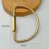 A brass keychain with a locking carabiner clip shown against a light background.