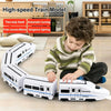 A child is playing with a white electric high-speed train model toy on a wooden floor.
