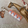 A brown horse is shown next to a clear acrylic fidget keychain with four colorful key buttons.