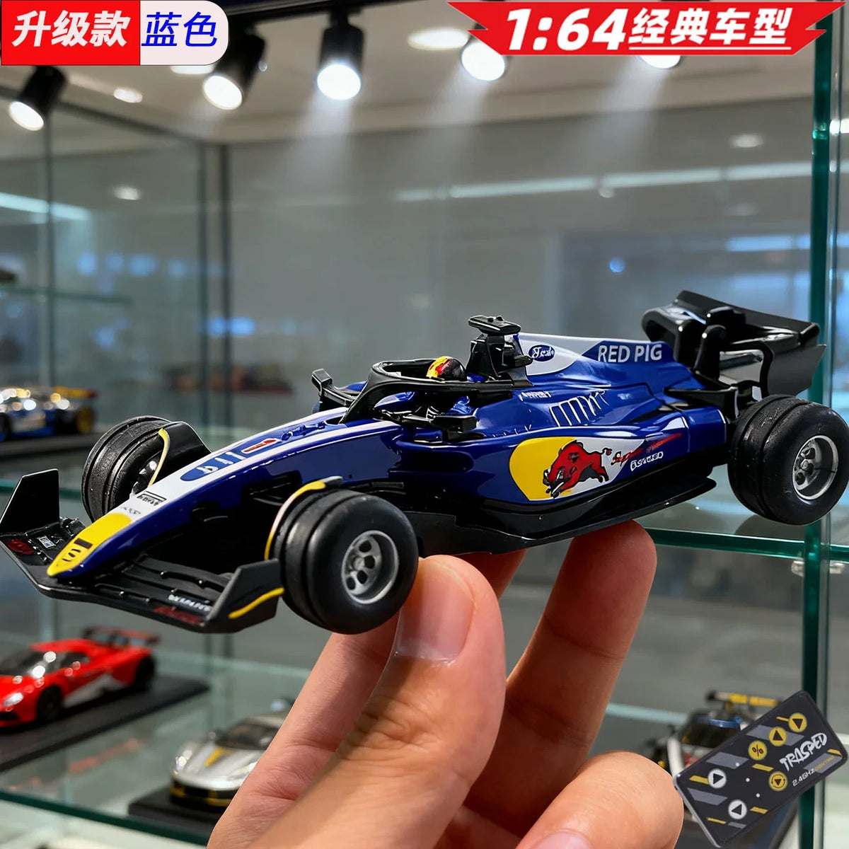 A blue 1:64 scale RC drift car with lights and APP control being held by a hand.