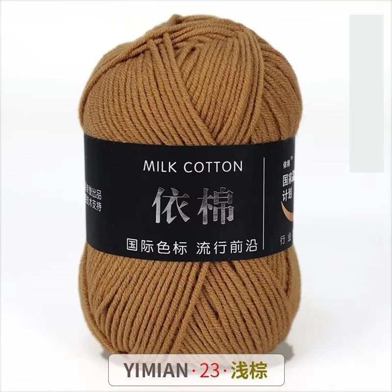 A ball of brown milk cotton yarn labeled YIMIAN 23 with Chinese characters for knitting and crochet.