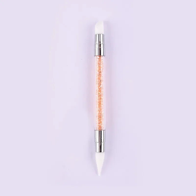 A dual-ended silicone head nail art dotting pen with a crystal handle and orange glitter tip.