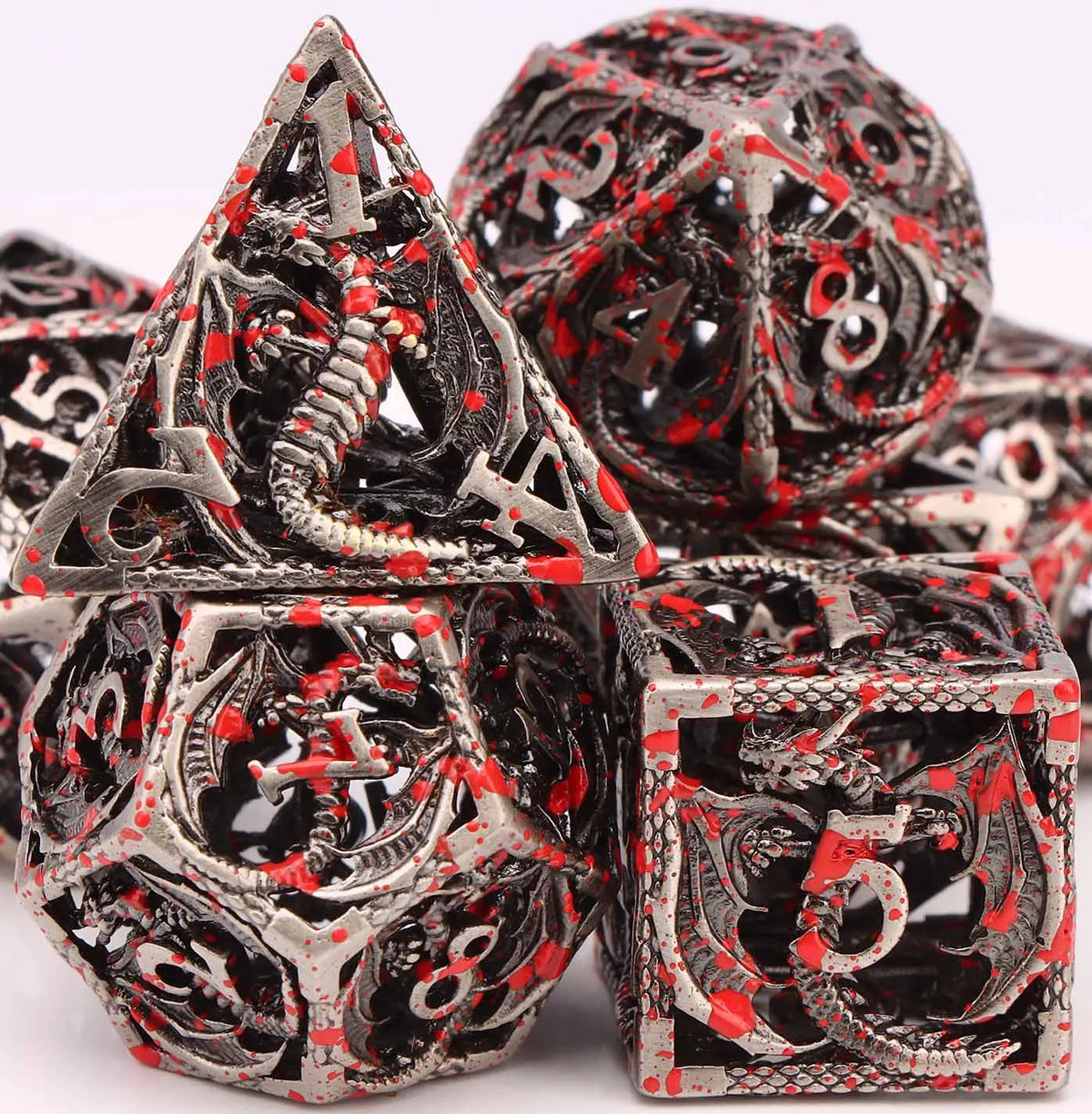 A pile of blood dragon metal dice set for D&D and tabletop RPGs showing various polyhedral dice.