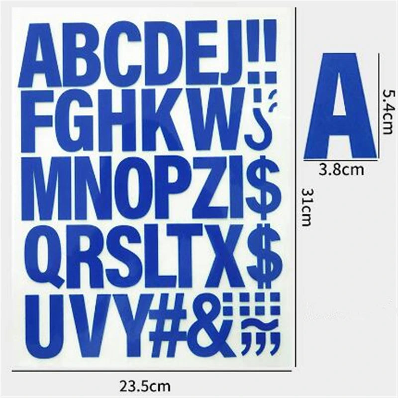A sheet of blue iron-on heat transfer patches showing the alphabet and symbols in large letters