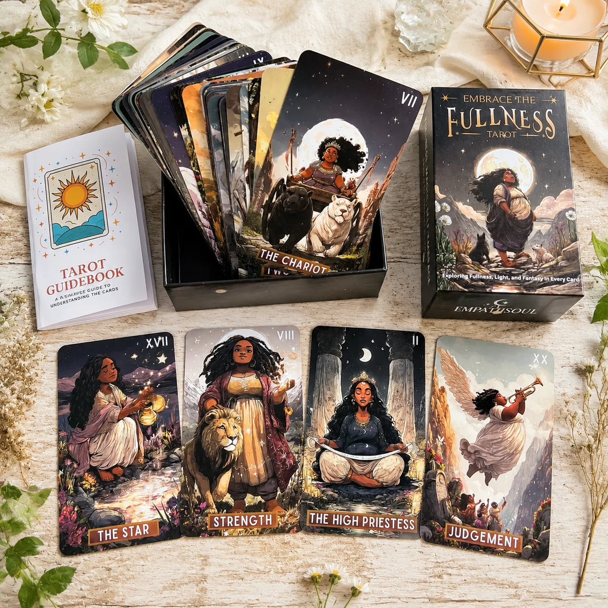 A collection of Embrace the Fullness Tarot cards and guidebook laid out on a wooden surface.
