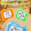 A set of mini magnetic drawing boards in orange, green, and blue plastic with attached keychains.