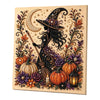 A framed canvas featuring a detailed diamond painting design of a witch silhouette with a crescent moon and autumn foliage.