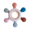 A silicone baby teether shaped like a rudder with a wooden ring and various colored silicone attachments.