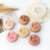 A collection of silicone face molds in various skin tones used for making candles and soap