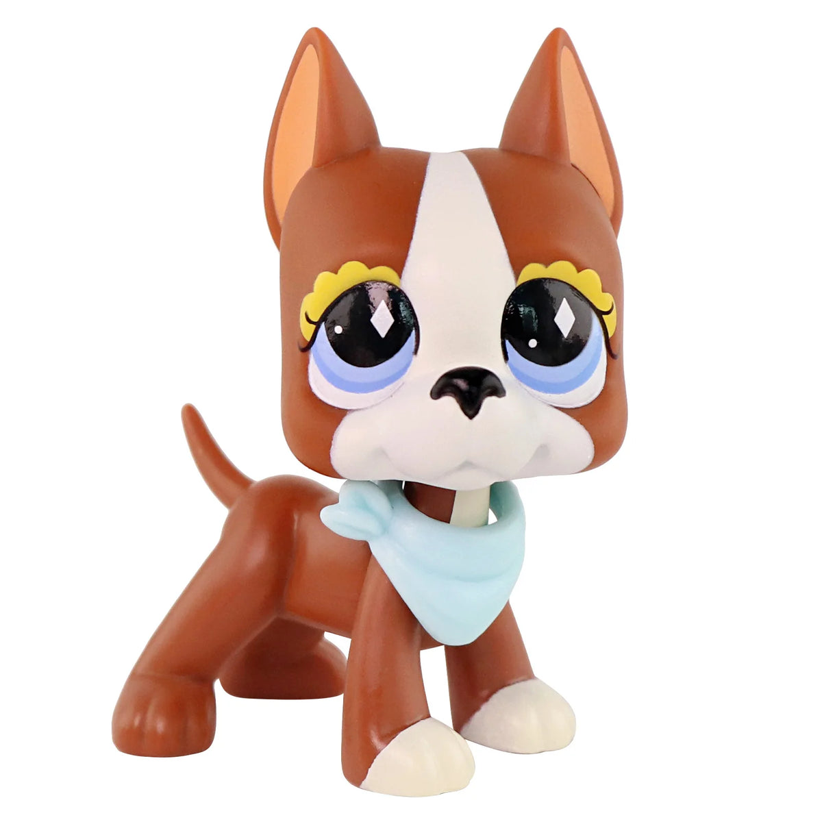 A miniature brown and white cat figure with yellow accents and a light blue accessory.