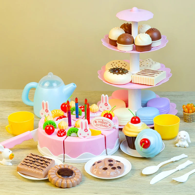 A pink and white DIY pretend play birthday cake tea set for kids featuring various food items and a tiered stand.