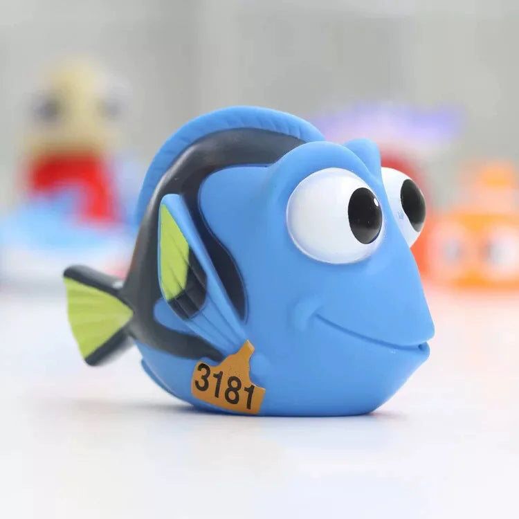 A blue rubber fish toy with a yellow mouth and the number 3181 is shown on a white surface.