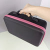 A hand is opening a black diamond painting storage organizer kit with a pink trim.