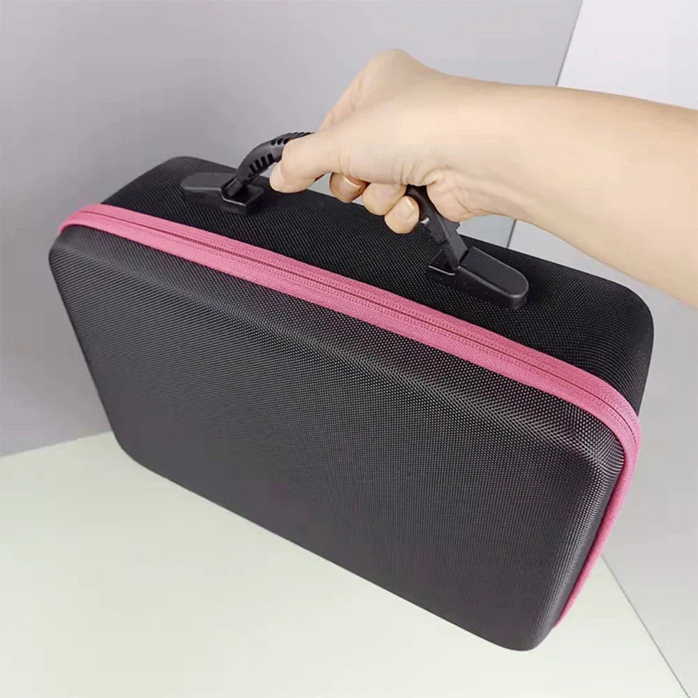 A hand is opening a black diamond painting storage organizer kit with a pink trim.