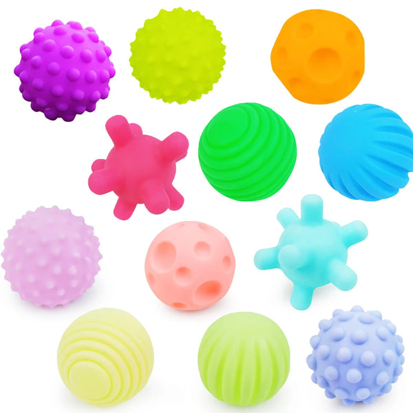 A collection of colorful textured sensory balls including purple, yellow, green, orange, pink, and blue spheres.
