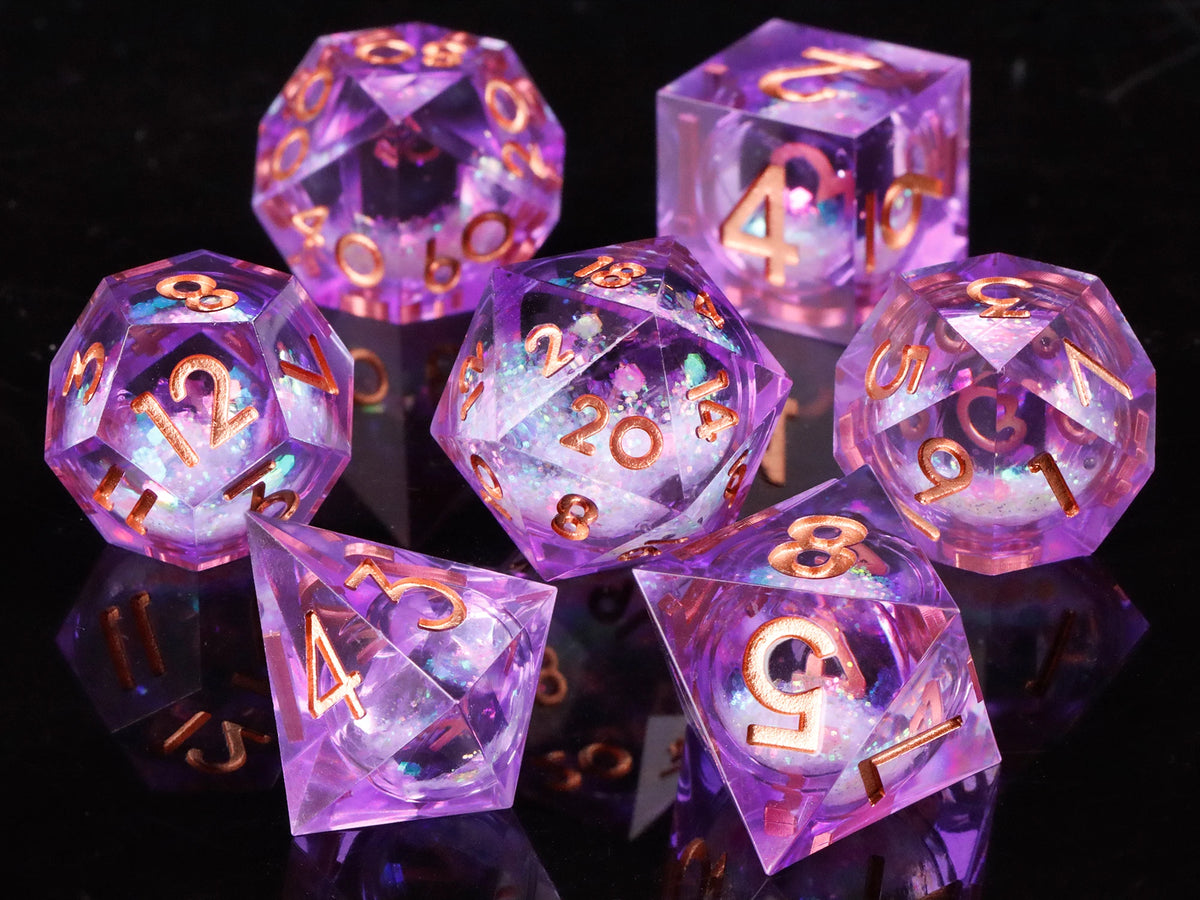 A collection of translucent purple liquid core dice, including d10s and d12s, displayed on a dark surface.