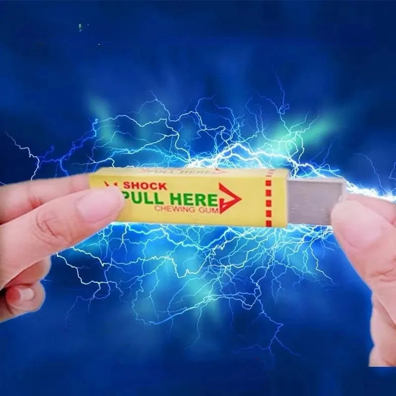 A hand holds a yellow box of electric shock chewing gum with lightning effects surrounding it.