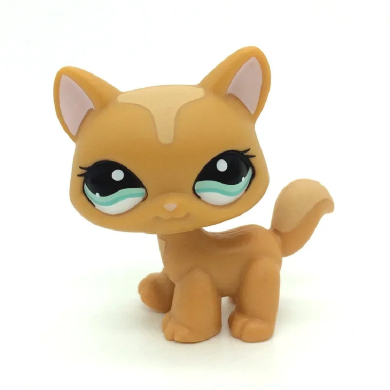 A small, standing dog figure resembling a cat with orange fur and large blue eyes.