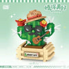 A green cactus building block set with a face, featuring a floral bouquet design.