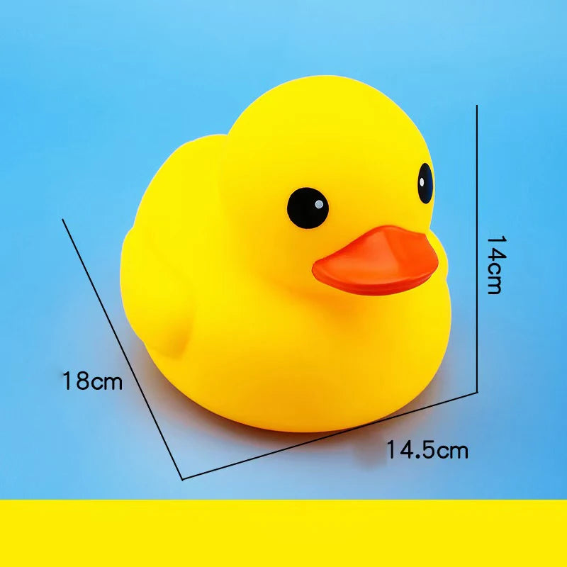 A bright yellow rubber duck toy with an orange beak, shown against a blue background and measurement lines.
