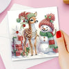 A watercolor illustration of a deer and a snowman decorated with festive Christmas elements on a greeting card.