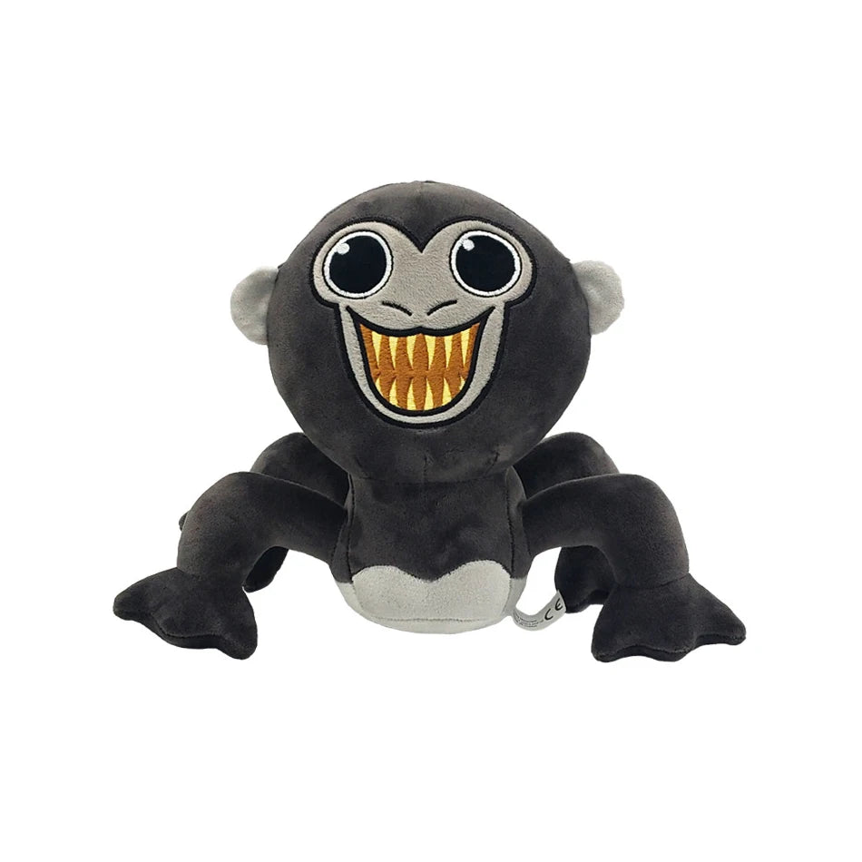 A black and gray plush toy of a monkey face with large eyes and an open mouth, resembling a gorilla.