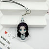 A clear acrylic pendant featuring a stylized character design attached to a black cord and metal keyring.
