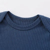 A navy blue cotton baby bodysuit with long sleeves shown from the chest view.