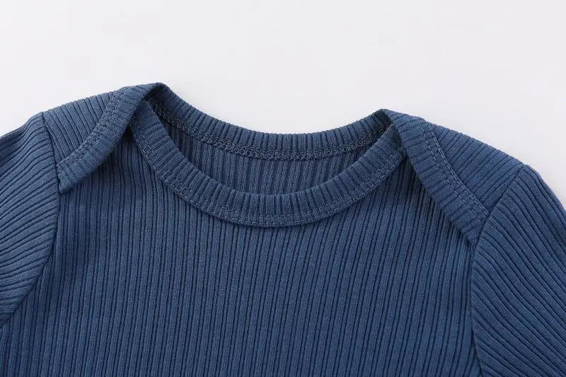 A navy blue cotton baby bodysuit with long sleeves shown from the chest view.