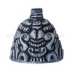 A dark, textured whistle shaped like an Aztec death skull, used as an eerie screaming noise maker.