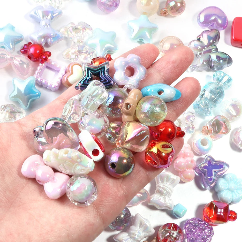 A hand holds a collection of colorful acrylic bow beads and various gemstone beads for DIY jewelry making.