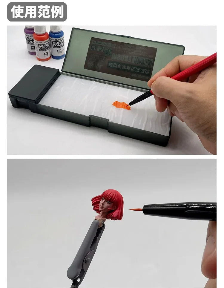 A hand is using a red brush to apply paint from a clear palette inside an open plastic case.