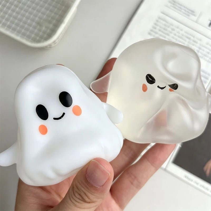 A hand holds a white squishy toy shaped like a cute ghost, demonstrating its moldable texture.