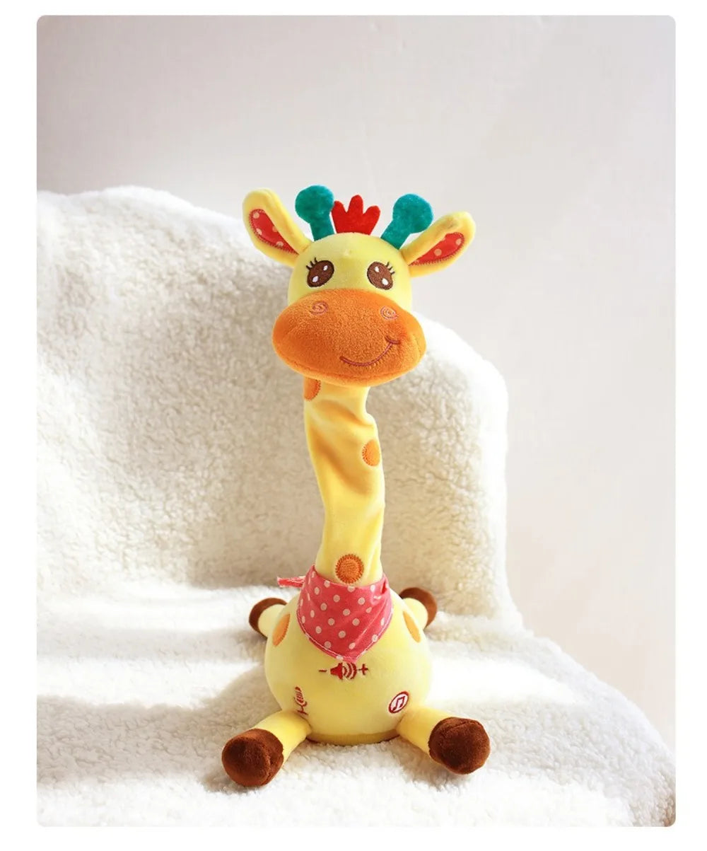 A yellow dancing talking giraffe plush toy with green accents resting on a white fluffy surface.