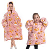 A young girl models a pink fuzzy flannel hoodie sweater for winter.