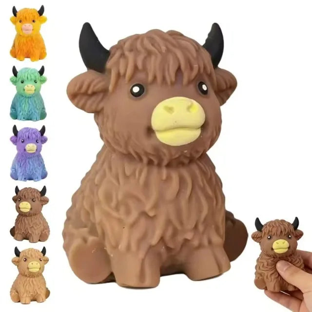 A collection of various colored cow squishy stress relief toys, including orange, green, purple, and brown.
