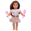 A doll with long brown hair is shown holding a pink hairbrush and a pink comb.