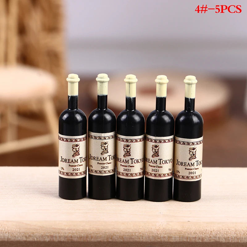 Five miniature resin wine bottles with corks and labels for a dollhouse set