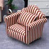 A miniature red and white striped sofa and pillow set for a dollhouse