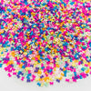 A pile of colorful polymer clay star and heart sprinkles in various bright colors like pink, blue, yellow, and purple.